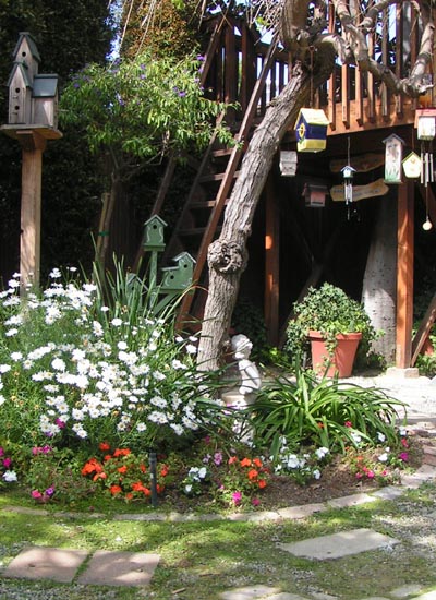 Several birdhouses and flowers in the Childhood Garden