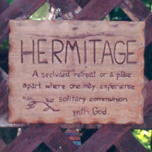 A sign that says "Hermitage A secluded retreat or a place apart where one may experience solitary communion"