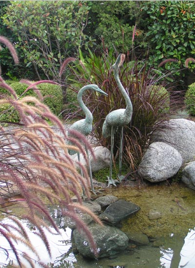 Two bronze cranes in the Reflection Pond