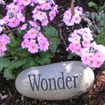 A rock that says a garden is heaven on earth